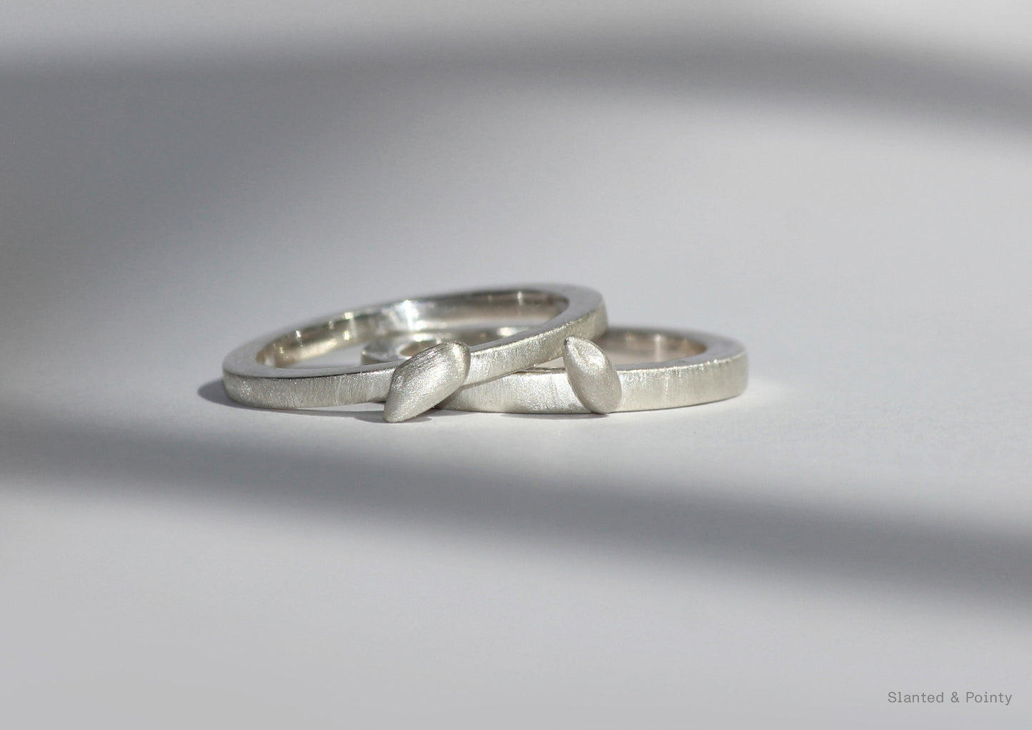 Silver rings inspired by rice that are paired together for a stackable ring set.